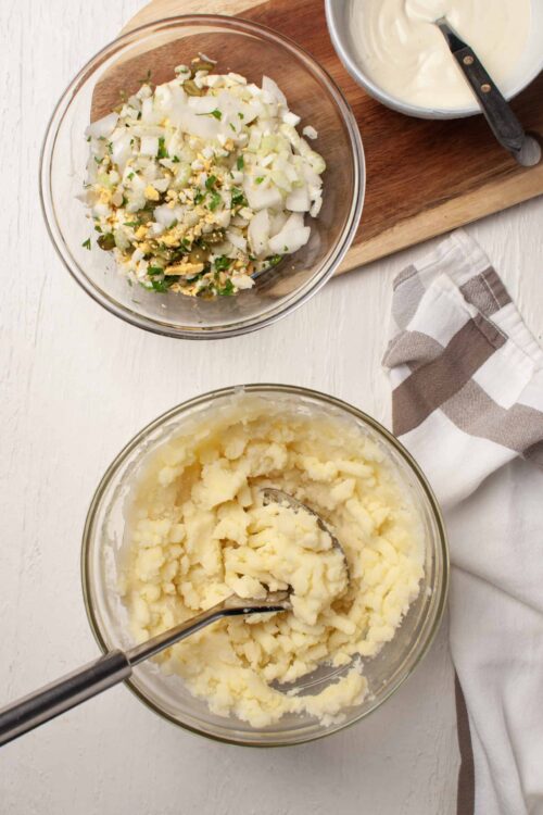 Creamy mashed potatoes with chopped green onions and hard-boiled eggs for a comfort food recipe.
