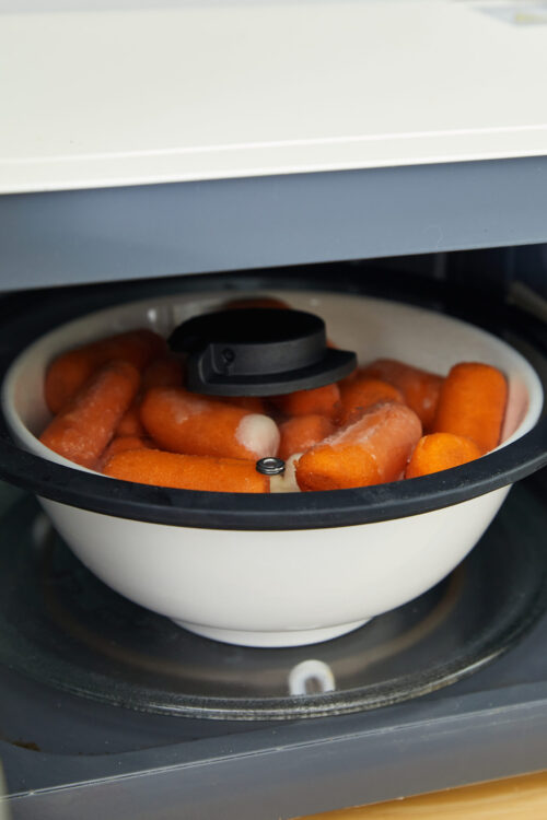 Steamed carrots in a slow cooker for healthy meal prep.