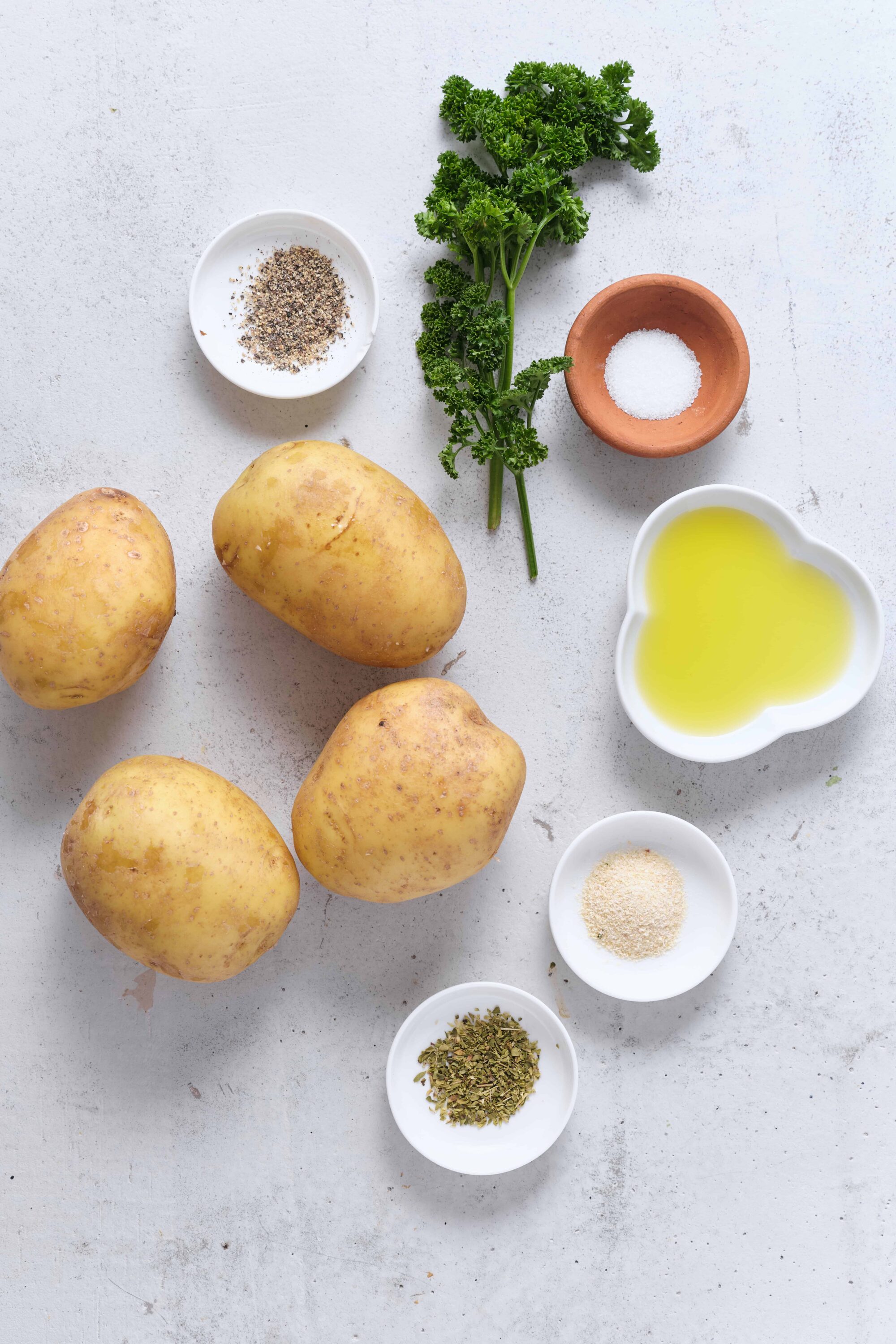 Fresh yellow potatoes with herbs and seasonings for baking recipes.