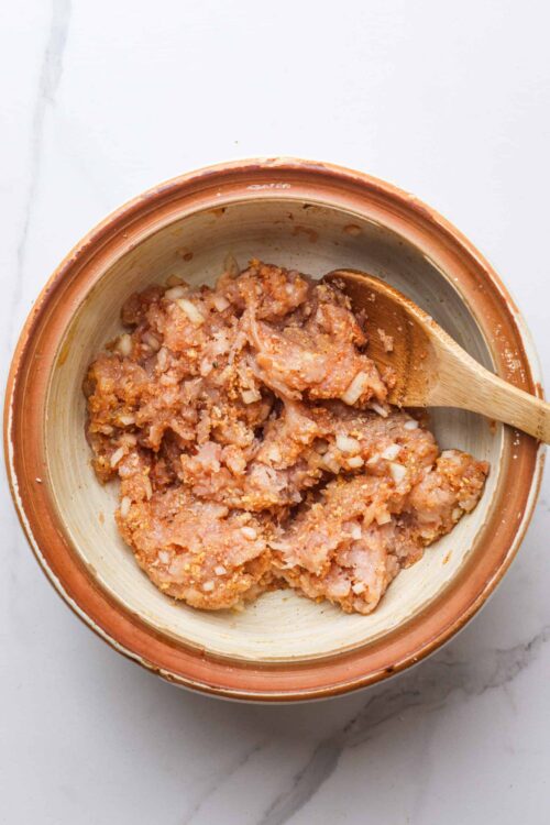 Creamy chicken and onion stuffing mixture in a rustic bowl ready for baking or serving. Perfect for holiday stuffing recipes.