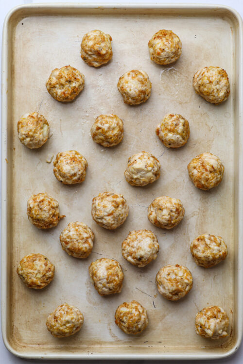 Savory homemade meatballs on a baking sheet, ready for baking, delicious comfort food.