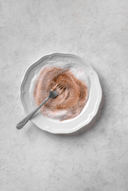 Fine sea salt and cinnamon in a white porcelain dish, salt and cinnamon mixture, baking ingredients, kitchen, baking spices, cooking essentials.