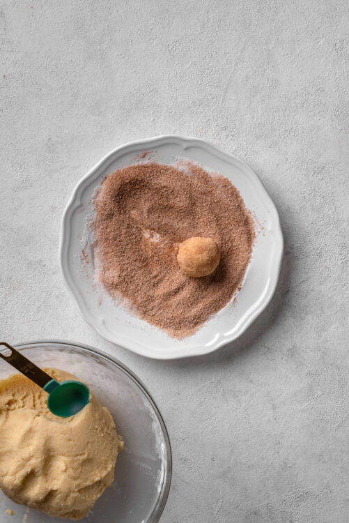 Chocolate truffle rolling ingredients with cocoa powder and dough.