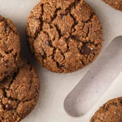 Chocolate chip cookies on parchment paper, freshly baked.