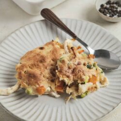 Buttery chicken pot pie with golden crust and colorful vegetable filling.