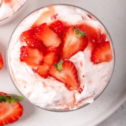Fresh strawberry shortcake dessert with whipped cream and sliced strawberries.