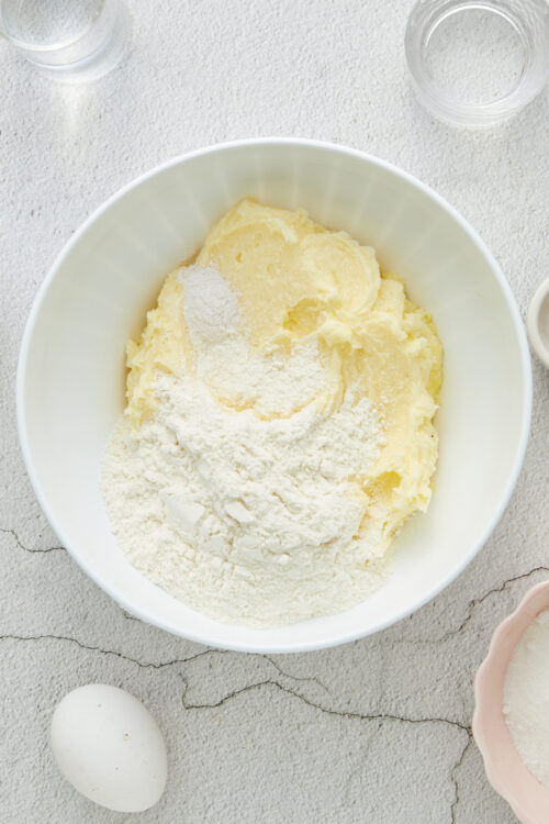 Cream cheese and butter for baking in a white mixing bowl.