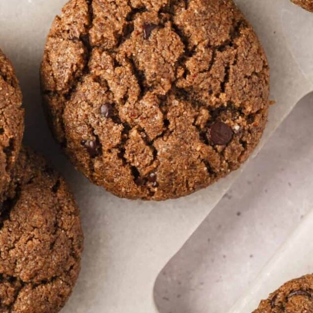 Chocolate chip cookies on parchment paper, freshly baked.