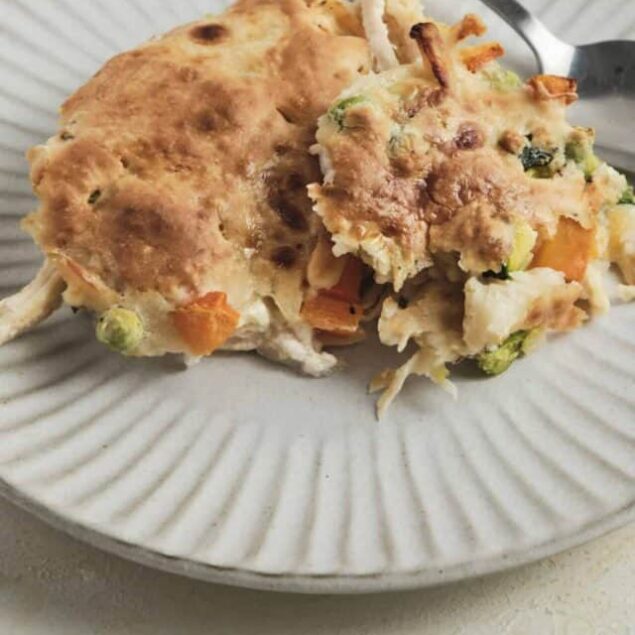 Buttery chicken pot pie with golden crust and colorful vegetable filling.