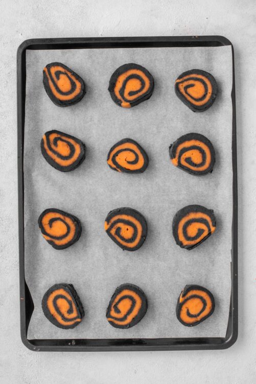 Sweet potato black bean burritos on baking sheet with parchment paper.