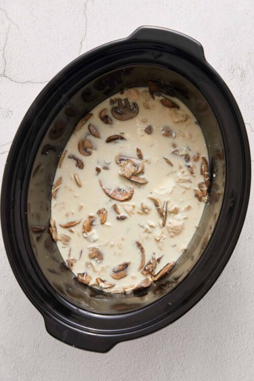 Creamy mushroom and garlic sauce in a slow cooker for pasta or chicken recipes.