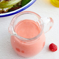 Raspberry Vinaigrette in a small glass pitcher shot from above