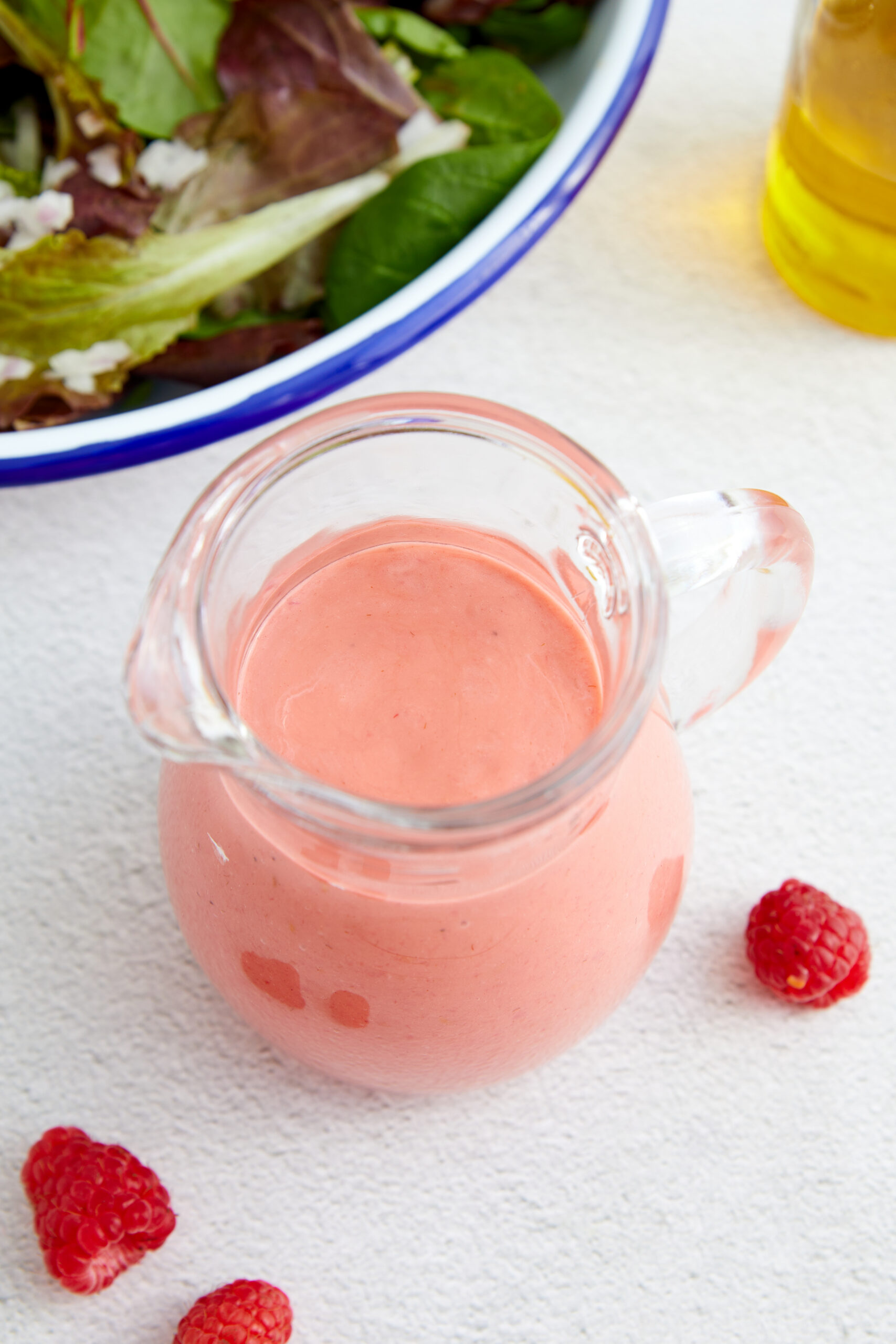 Raspberry Vinaigrette in a small glass pitcher shot from above
