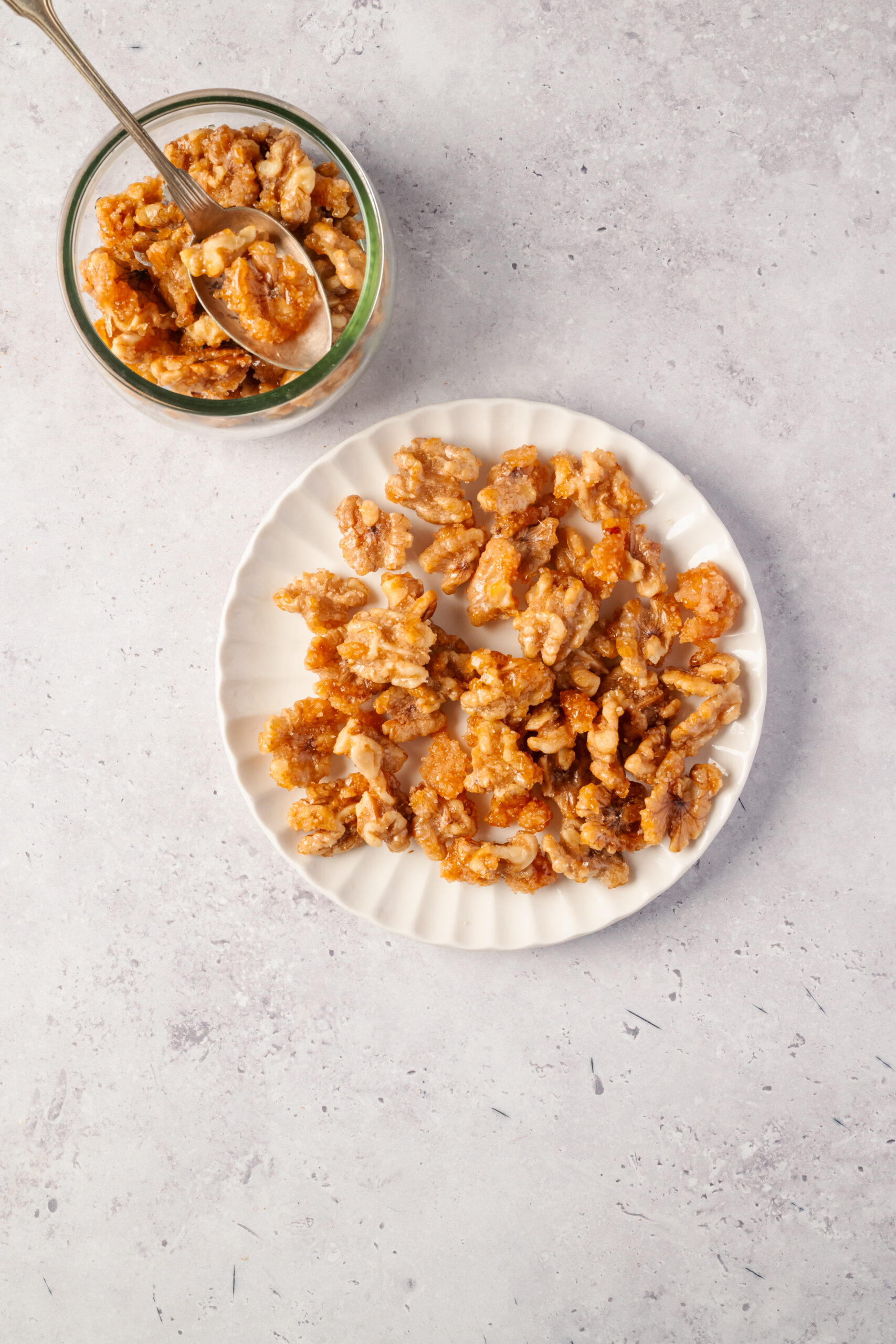 Candied Walnuts in a plate and a bowl shot from above