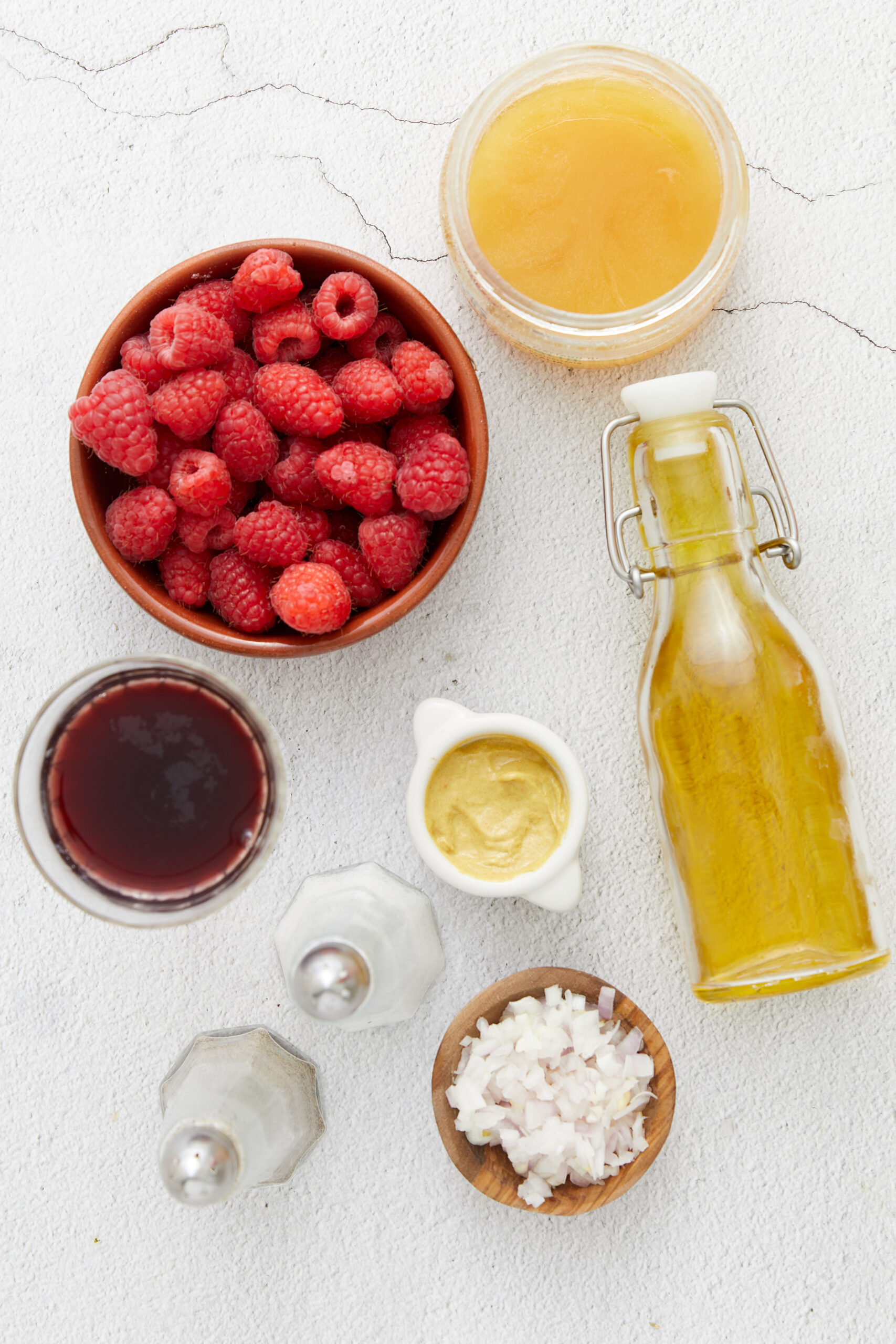 Raspberry Vinaigrette in a small glass pitcher shot from the side