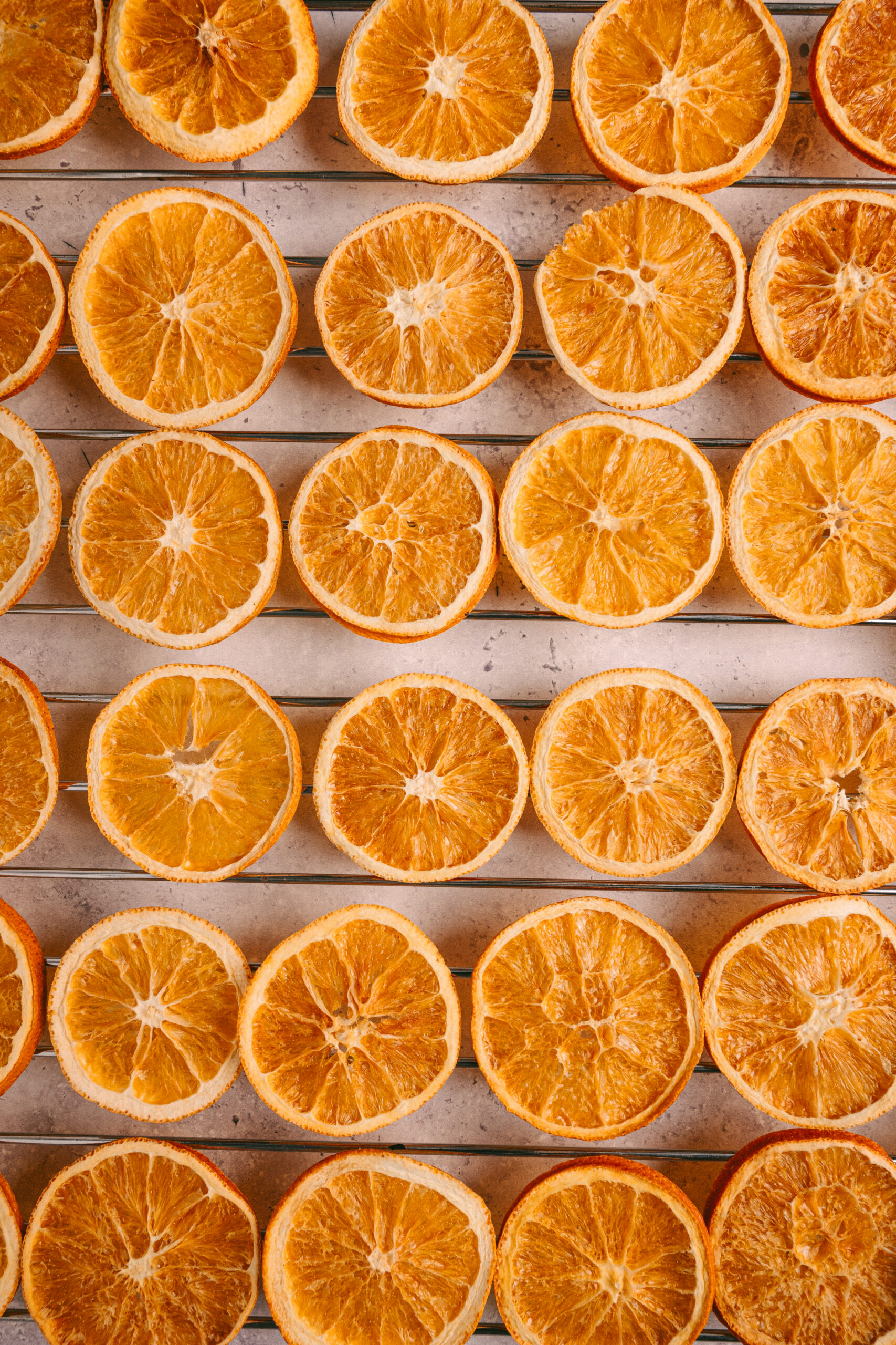 Dry Orange Slices lined-up on a tray shot from above